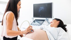 Diagnostic Imaging for Women Sonographer giving a pregnant women an ultrasound