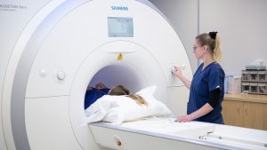 SRG Radiologist in takanini scanning a patient in a CT machine